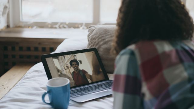 A tidy home office corner with a laptop open on a video call